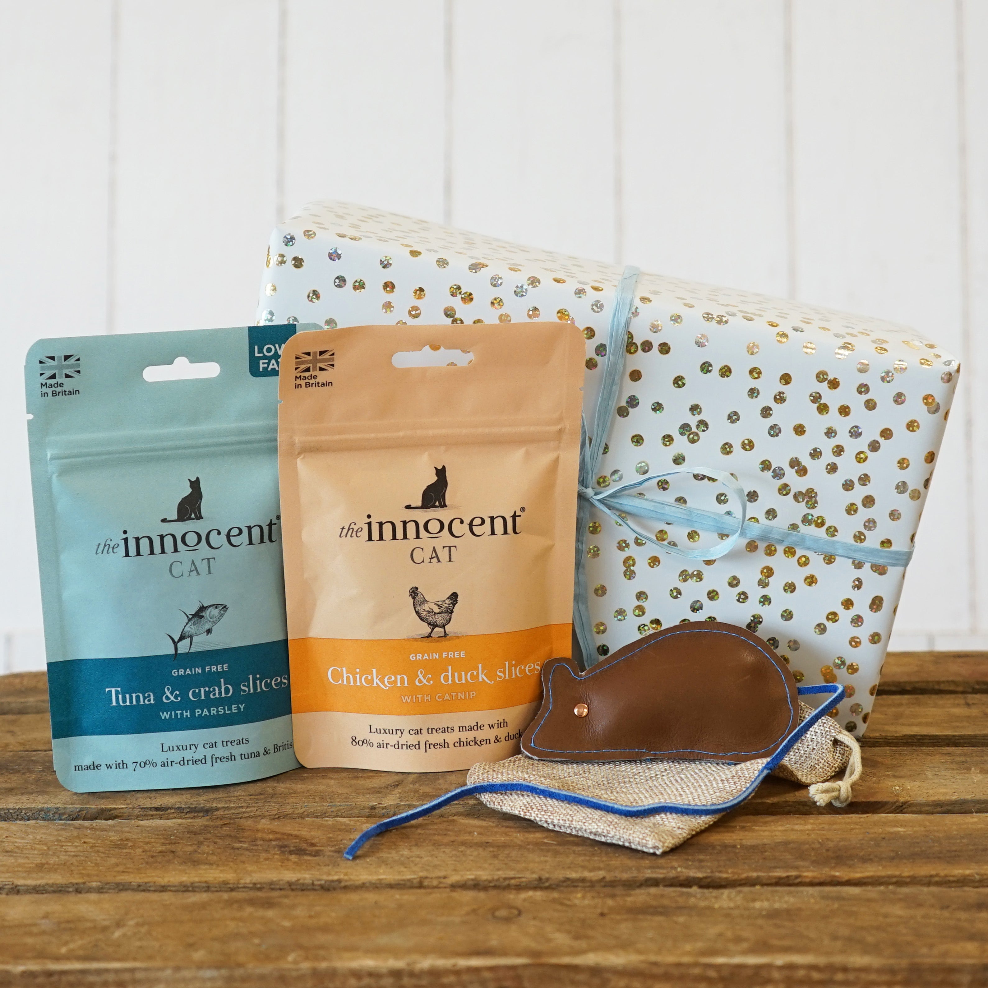 Cat gift box containing healthy air-dried cat treats and a leather mouse 